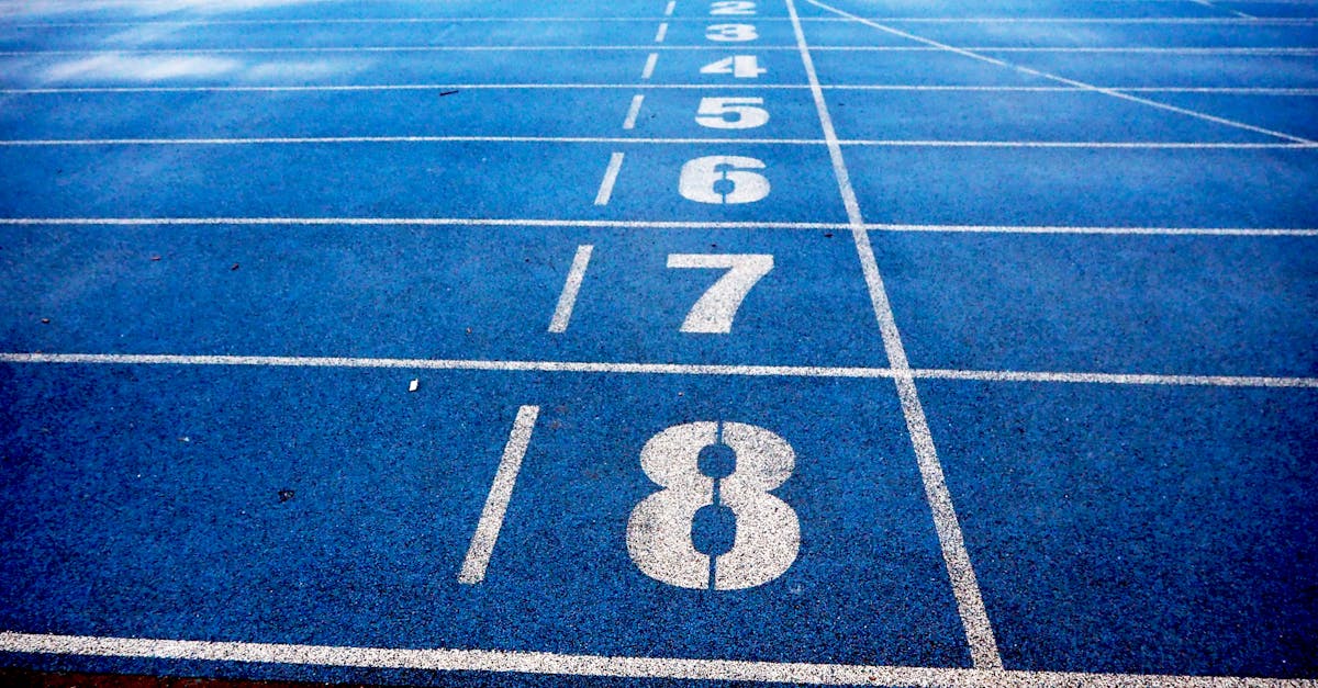Blue athletic running track with numbered lanes, ideal for sports events and race preparations.